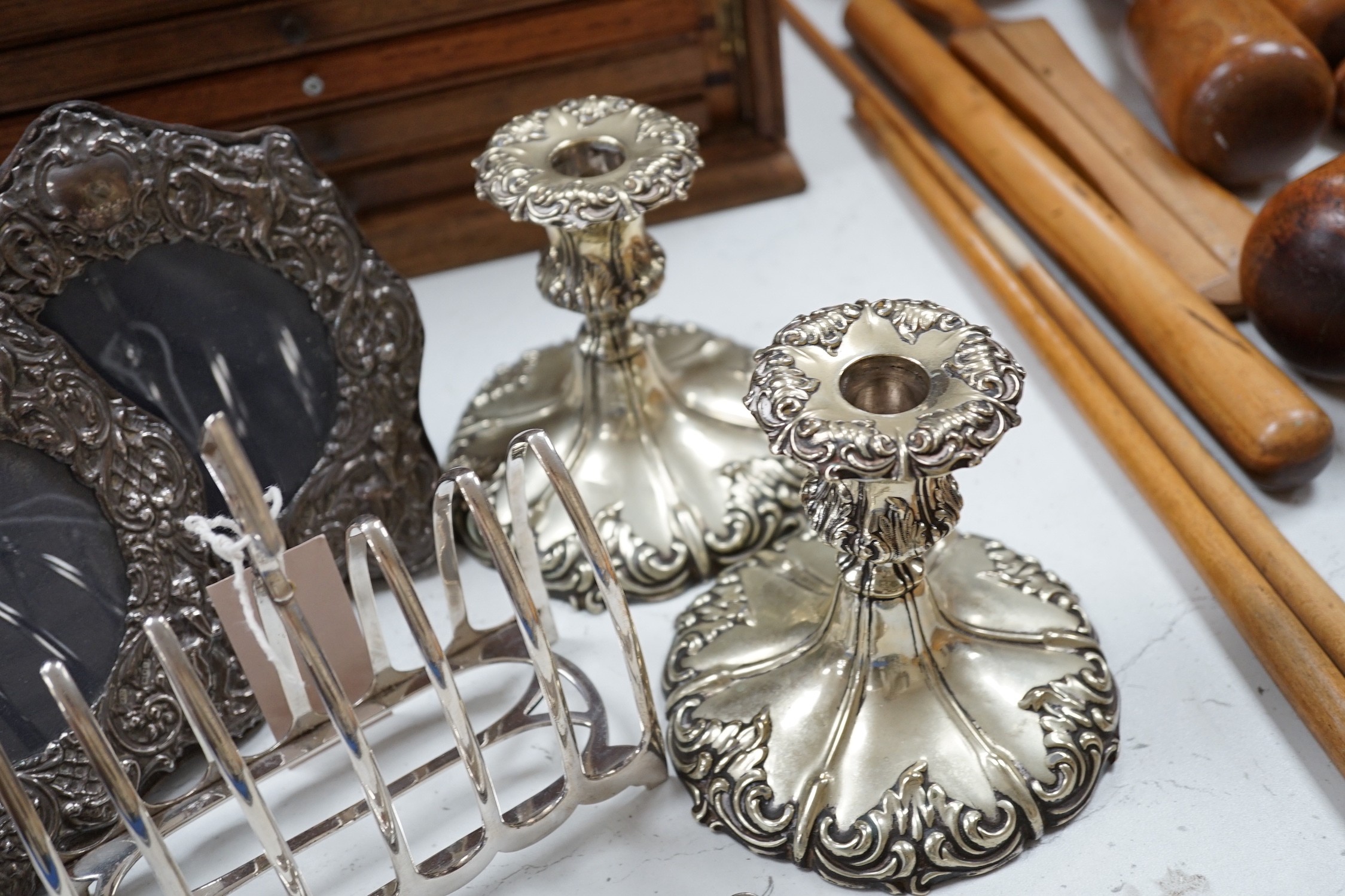 A pair of embossed silver photograph frames and plated wares